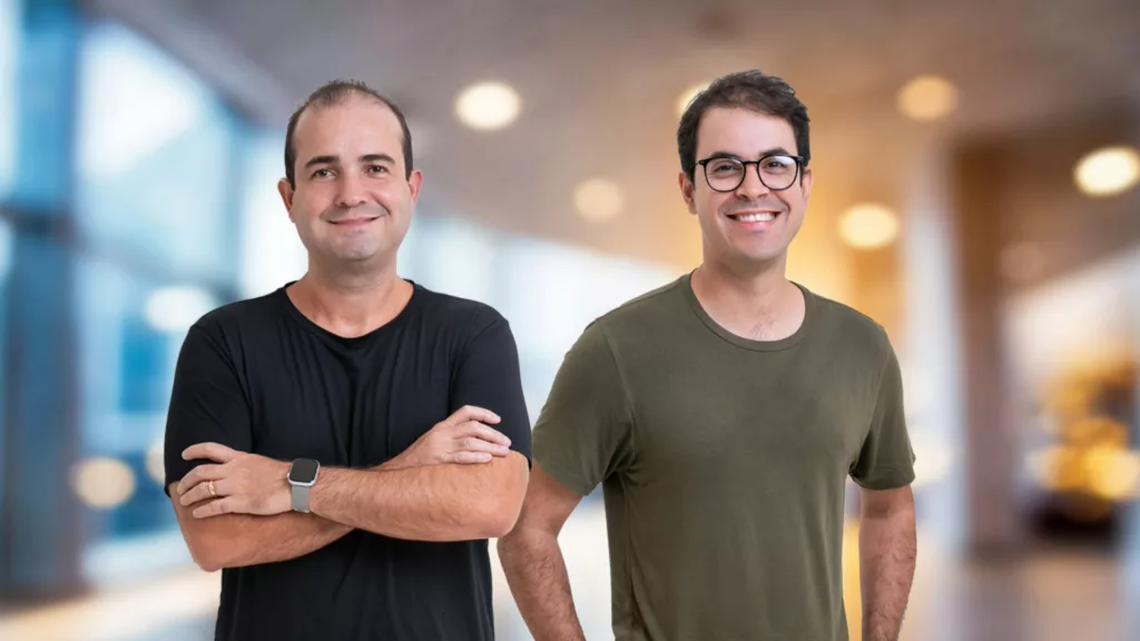 Fundadores da Baasic lado a lado, sorrindo, em ambiente corporativo